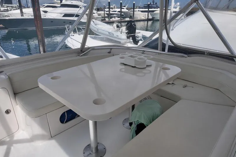  Yacht Photos Pics Interior of 2007 Bertram 510 Convertible yacht with seating and table, docked at marina.