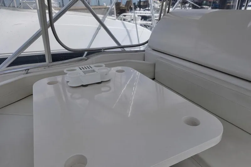  Yacht Photos Pics Interior of 2007 Bertram 510 Convertible yacht with sleek white seating and table.