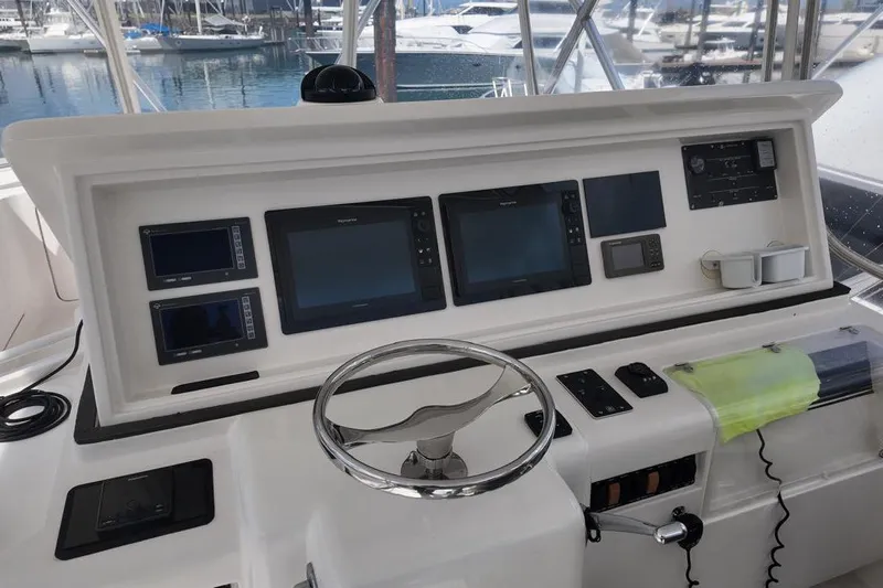  Yacht Photos Pics 2007 Bertram 510 Convertible yacht helm with navigation screens and steering wheel.
