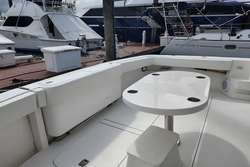  Yacht Photos Pics 2007 Bertram 510 Convertible yacht deck with table and seating at marina.