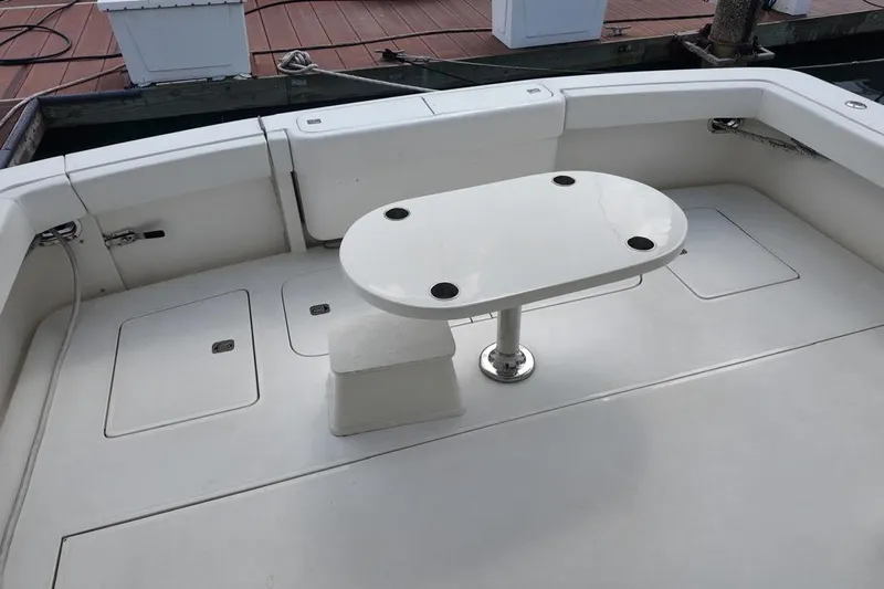  Yacht Photos Pics 2007 Bertram 510 Convertible boat deck with table and storage compartments.