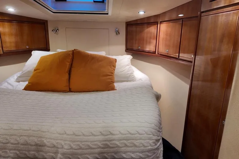  Yacht Photos Pics Luxurious cabin interior of 2007 Bertram 510 Convertible yacht with cozy bedding.