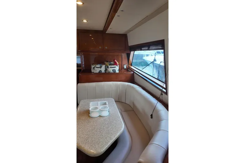  Yacht Photos Pics Luxurious interior of 2007 Bertram 510 Convertible yacht with plush seating and elegant table.