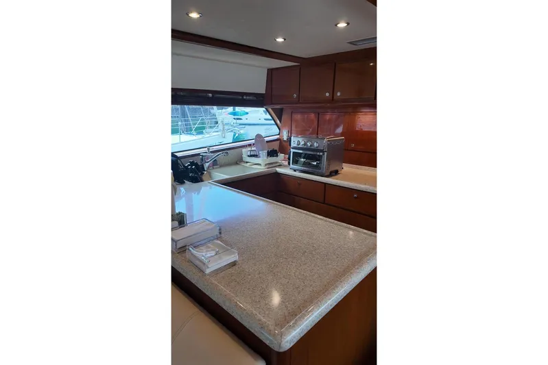  Yacht Photos Pics Interior of 2007 Bertram 510 Convertible yacht kitchen with modern appliances and wood cabinetry.