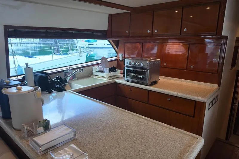  Yacht Photos Pics Luxurious kitchen interior of 2007 Bertram 510 Convertible yacht with modern appliances.