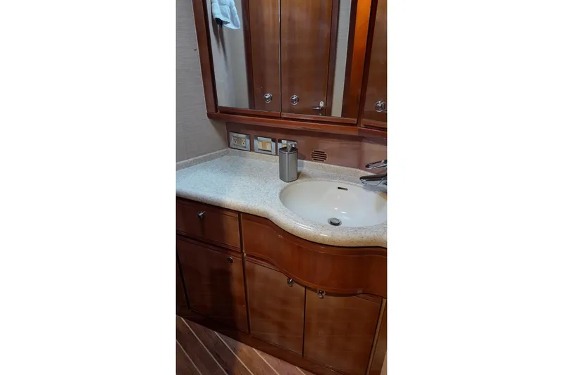  Yacht Photos Pics Bathroom vanity in 2007 Bertram 510 Convertible yacht with wooden cabinets and mirror.