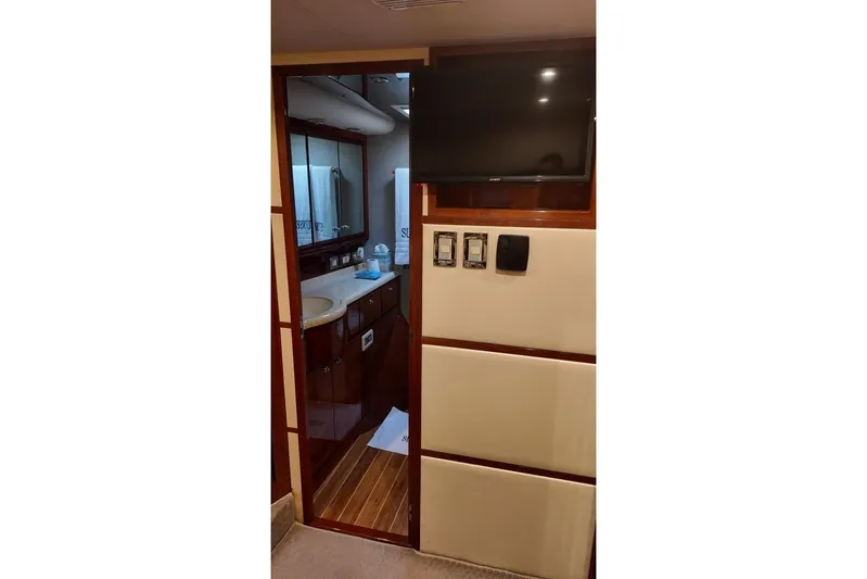  Yacht Photos Pics Interior of 2007 Bertram 510 Convertible yacht, featuring a bathroom and mounted TV.