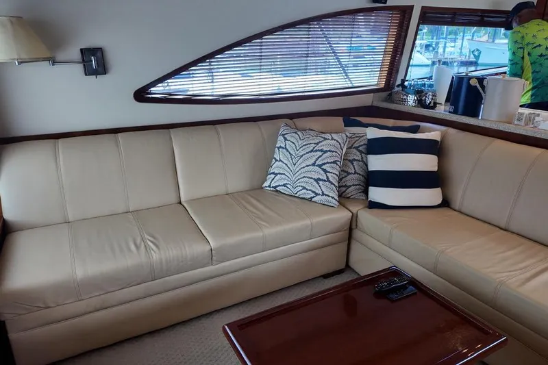  Yacht Photos Pics Luxurious interior of 2007 Bertram 510 Convertible yacht with beige leather seating and decorative pillows.