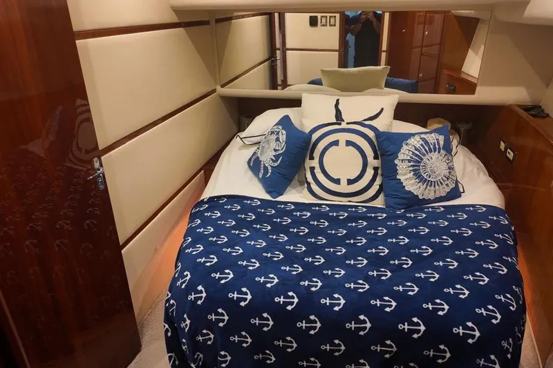  Yacht Photos Pics Luxurious bedroom interior of 2007 Bertram 510 Convertible yacht with nautical-themed decor.
