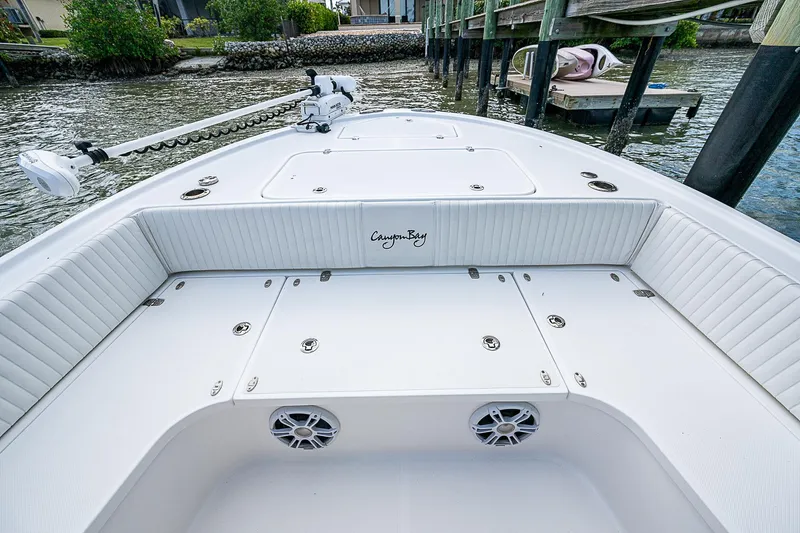  Yacht Photos Pics 2022 Canyon Bay 28h boat interior with white seating and storage compartments.