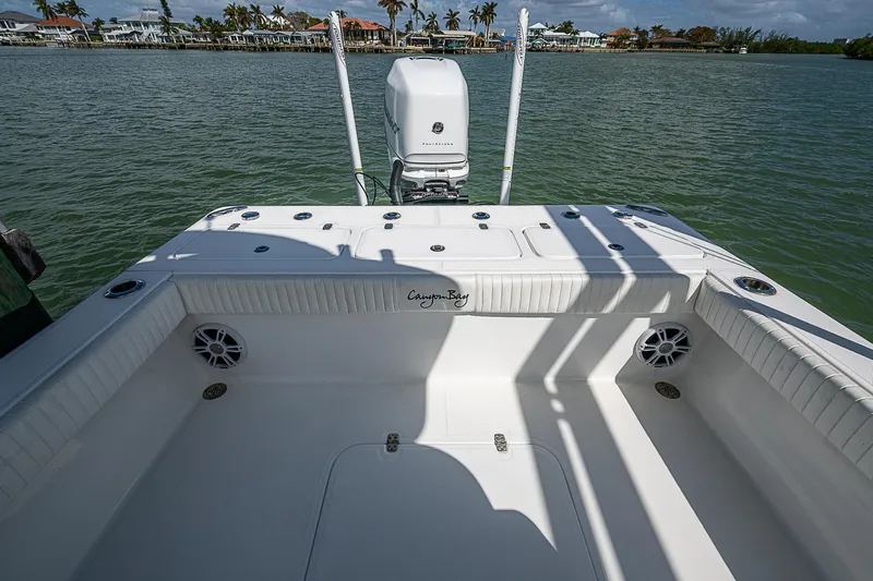  Yacht Photos Pics 2022 Canyon Bay 28h boat deck with motor, on calm water.