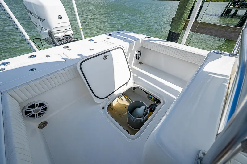  Yacht Photos Pics 2022 Canyon Bay 28h boat deck with open storage compartment, near water.