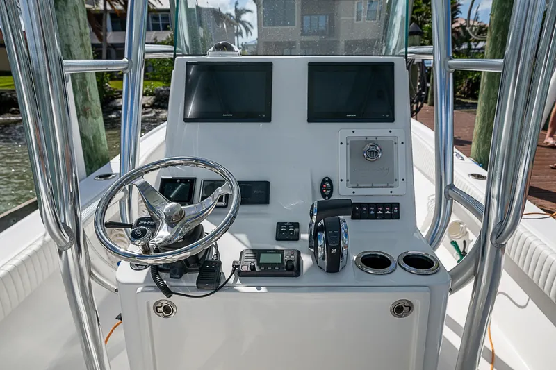  Yacht Photos Pics Canyon Bay 28h 2022 boat console with steering wheel and navigation screens.