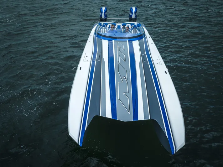  Yacht Photos Pics 2024 MTI 440X powerboat with blue and gray stripes on open water.