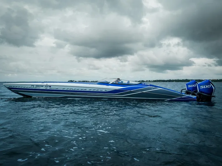  Yacht Photos Pics 2024 MTI 440X speedboat on water under cloudy sky.