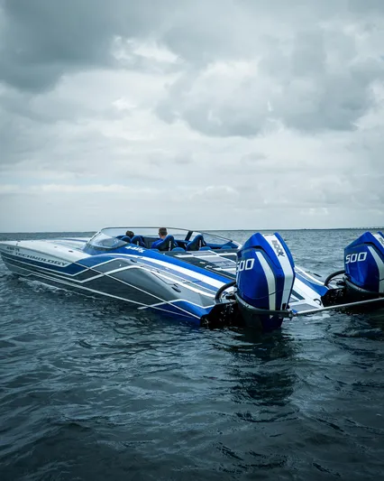  Yacht Photos Pics 2024 MTI 440X powerboat with dual engines on open water under cloudy skies.