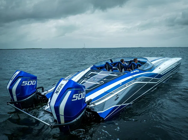  Yacht Photos Pics 2024 MTI 440X powerboat with dual 500 engines on open water under cloudy skies.
