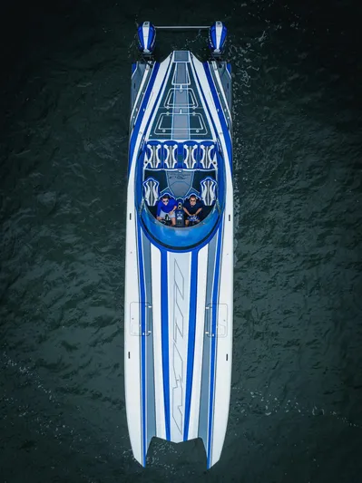  Yacht Photos Pics Aerial view of 2024 MTI 440X speedboat with blue and white stripes on water.