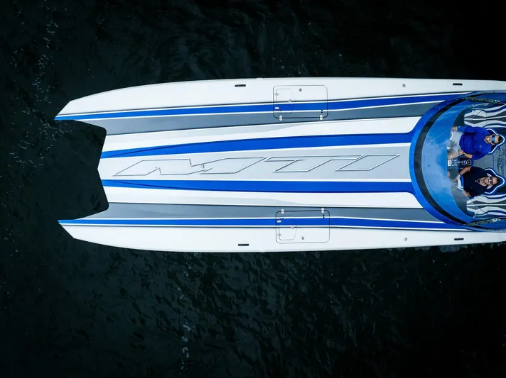  Yacht Photos Pics Aerial view of 2024 MTI 440X speedboat with sleek blue and white design.