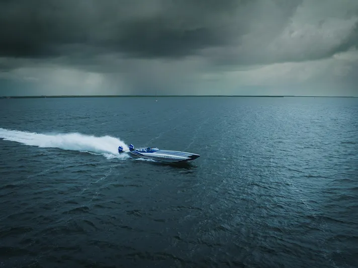  Yacht Photos Pics 2024 MTI 440X speedboat racing on open water under stormy skies.