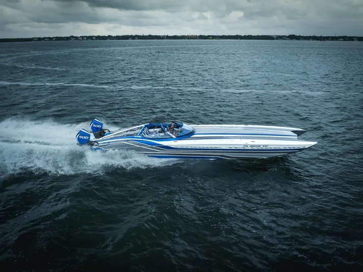  Yacht Photos Pics 2024 MTI 440X speedboat cruising on open water under cloudy skies.