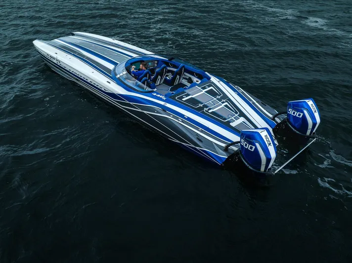  Yacht Photos Pics 2024 MTI 440X speedboat with blue and white design on open water.