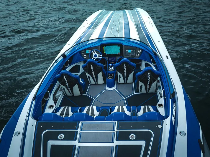  Yacht Photos Pics 2024 MTI 440X speedboat with blue and white interior on open water.