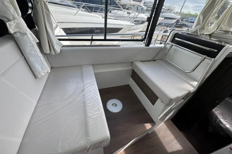  Yacht Photos Pics Interior of 2026 Jeanneau NC 895 Series 2 boat, featuring seating and windows.