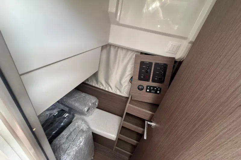  Yacht Photos Pics Interior of 2026 Jeanneau NC 895 Series 2 boat, featuring control panels and storage area.