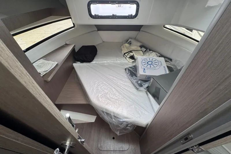  Yacht Photos Pics Interior cabin of 2026 Jeanneau NC 895 Series 2 boat, featuring a cozy sleeping area.