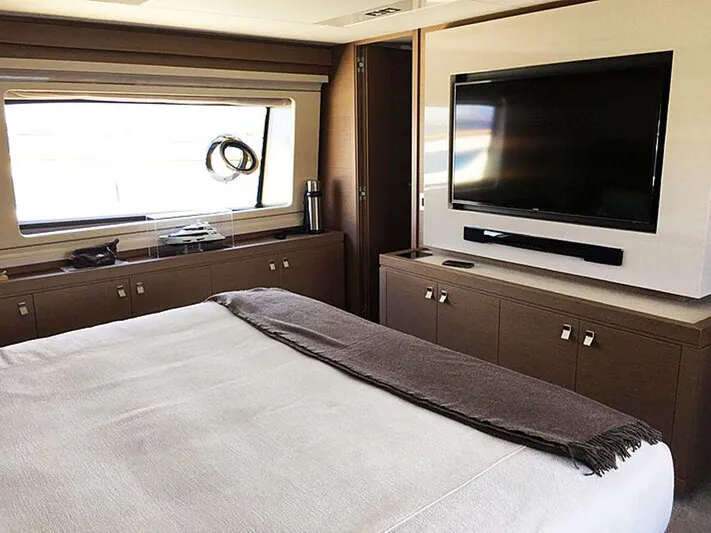  Yacht Photos Pics Luxurious bedroom interior of 2017 Custom Line Navetta 28 yacht with modern decor and large TV.