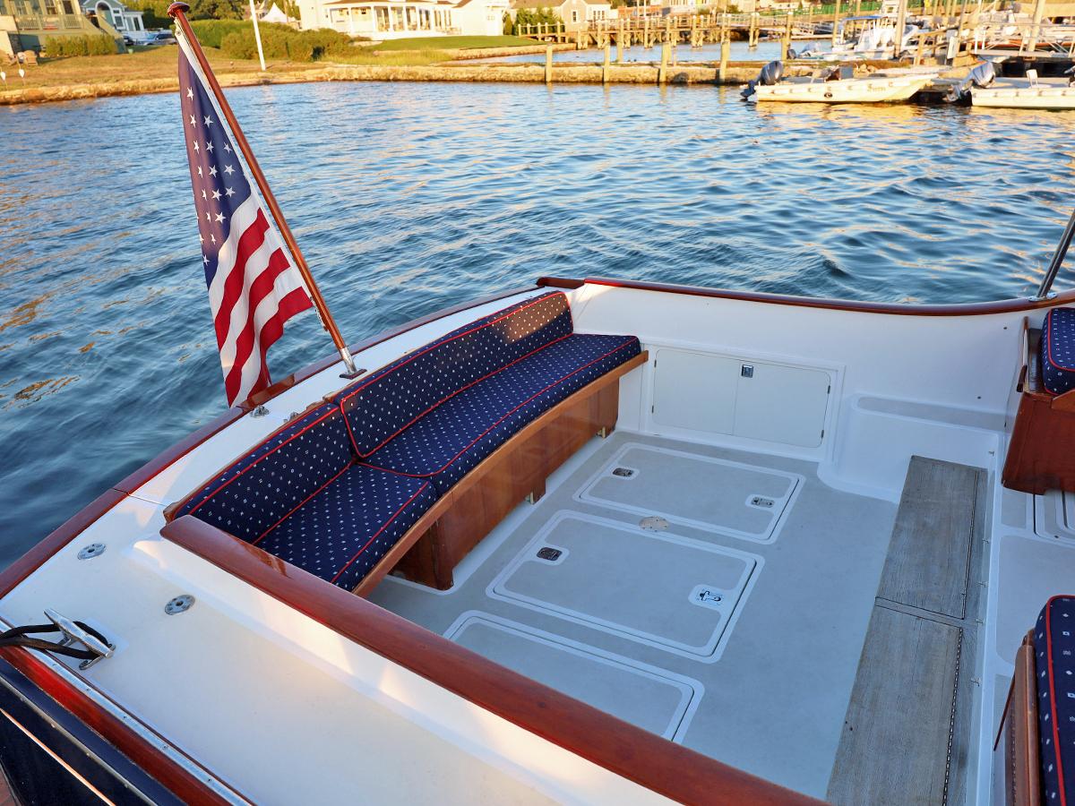 1995 Able 44 boat deck with American flag, docked by calm waters.