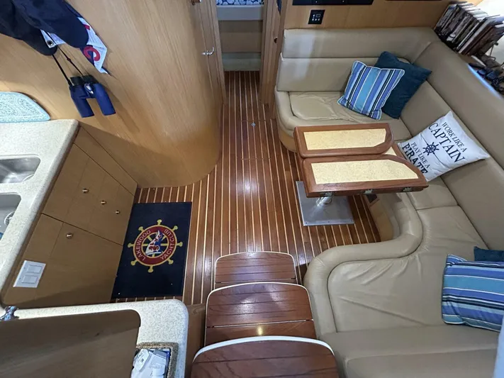Native Dancer Yacht Photos Pics Interior of 2002 Tiara Yachts 3800 Open with wood flooring and cozy seating area.