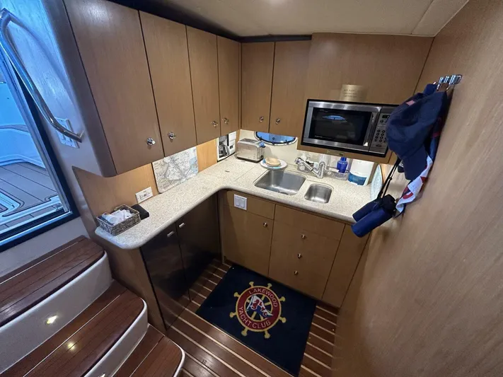 Native Dancer Yacht Photos Pics 2002 Tiara Yachts 3800 Open galley with wood cabinets and modern appliances.