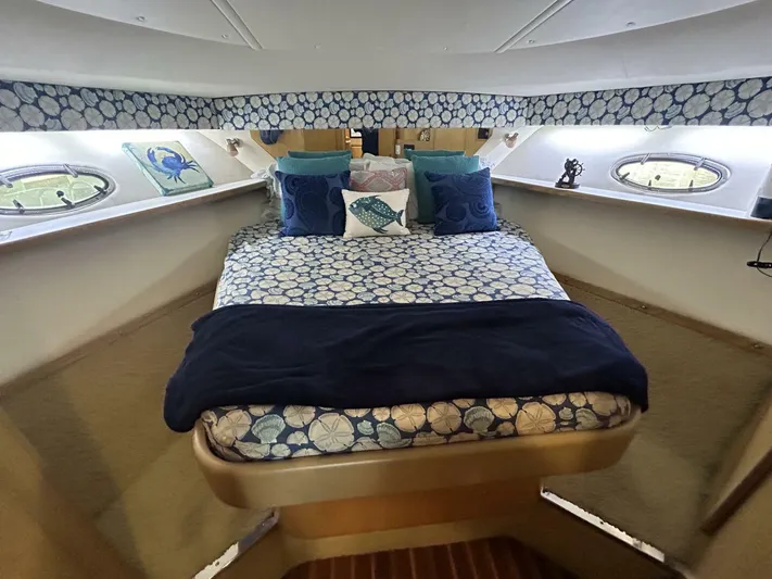 Native Dancer Yacht Photos Pics Luxurious 2002 Tiara Yachts 3800 Open cabin with cozy bedding and nautical decor.