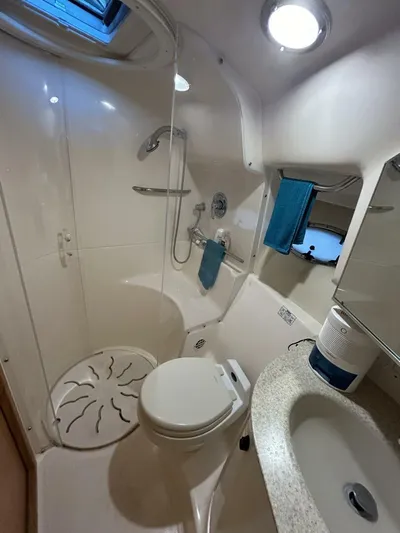 Native Dancer Yacht Photos Pics 2002 Tiara Yachts 3800 Open bathroom with shower, toilet, and sink.