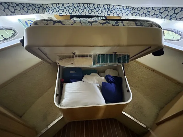 Native Dancer Yacht Photos Pics Tiara Yachts 3800 Open 2002 cabin storage with bedding and pillows.