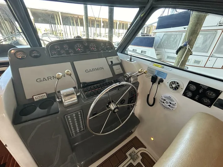 Native Dancer Yacht Photos Pics 2002 Tiara Yachts 3800 Open helm with Garmin navigation and steering wheel.