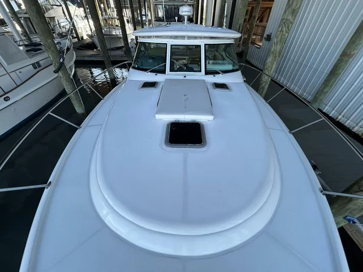 Native Dancer Yacht Photos Pics 2002 Tiara Yachts 3800 Open docked, showcasing sleek white deck design.