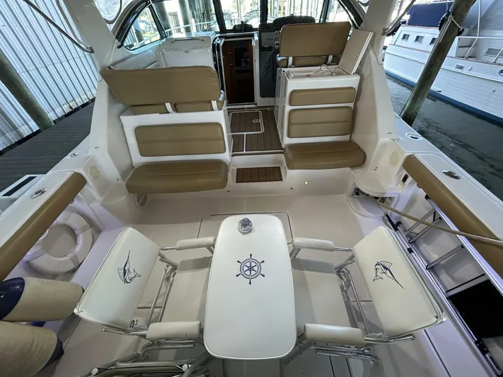 Native Dancer Yacht Photos Pics Interior of 2002 Tiara Yachts 3800 Open with seating and table setup.