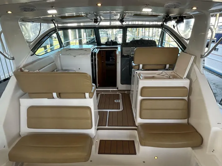 Native Dancer Yacht Photos Pics Interior of 2002 Tiara Yachts 3800 Open with beige seating and wood flooring.