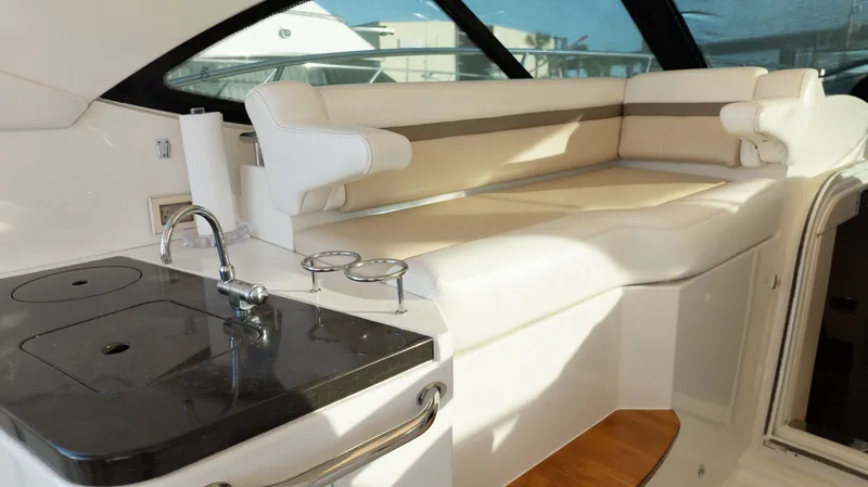  Yacht Photos Pics Luxurious interior of 2014 Sea Ray 410 Sundancer yacht with seating and kitchenette.