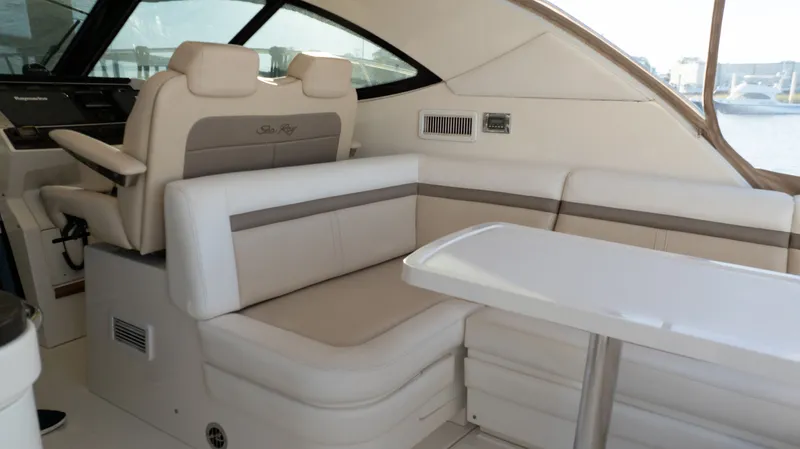  Yacht Photos Pics Interior of 2014 Sea Ray 410 Sundancer yacht with beige seating and table.