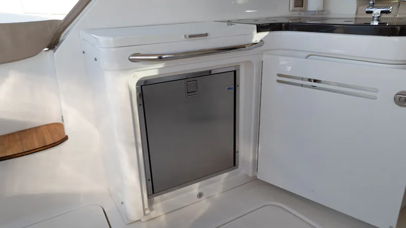  Yacht Photos Pics 2014 Sea Ray 410 Sundancer yacht interior with sleek kitchenette and stainless steel appliances.