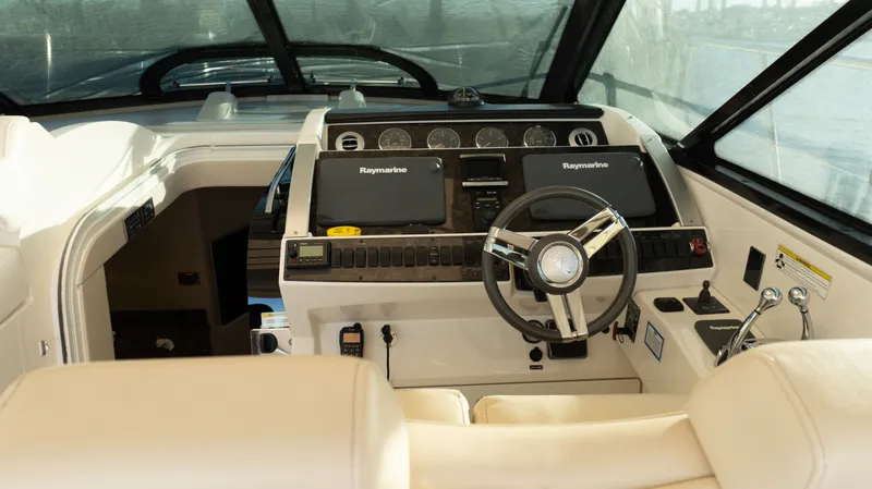  Yacht Photos Pics Helm of 2014 Sea Ray 410 Sundancer with Raymarine electronics and leather seating.