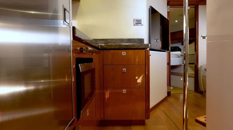  Yacht Photos Pics Interior of 2014 Sea Ray 410 Sundancer yacht, featuring modern kitchen and cozy cabin.