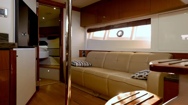  Yacht Photos Pics Luxurious interior of 2014 Sea Ray 410 Sundancer yacht with beige leather seating.