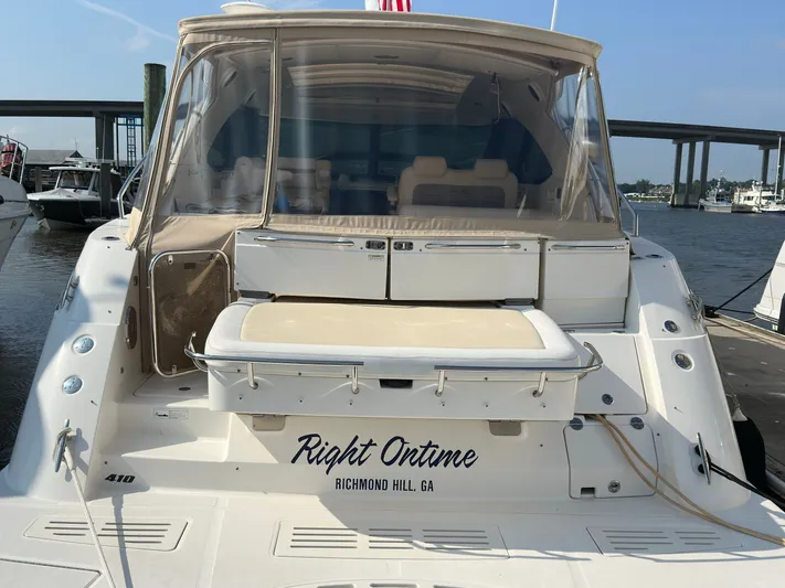  Yacht Photos Pics 2014 Sea Ray 410 Sundancer yacht docked, featuring spacious seating and clear enclosure.