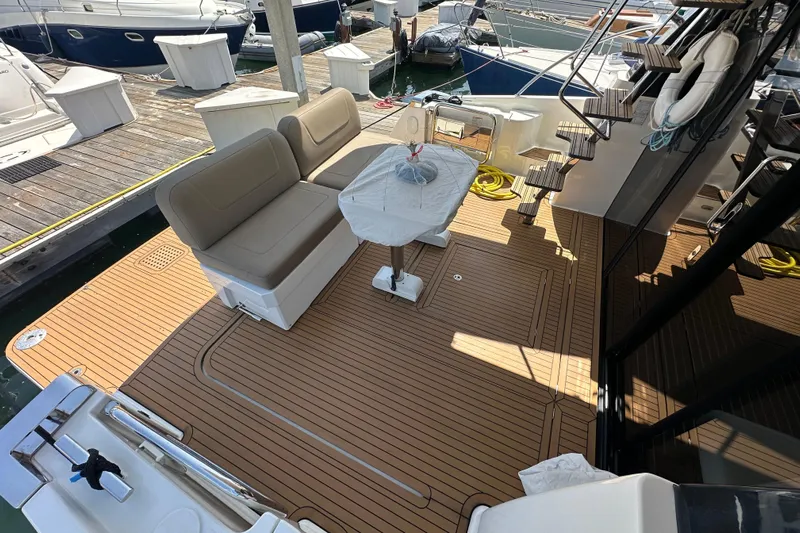 Sweet Yacht Photos Pics 2017 Bavaria Virtess 420 Fly yacht deck with seating and table at marina.