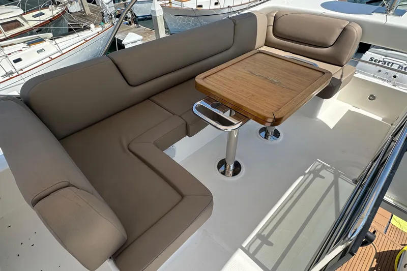 Sweet Yacht Photos Pics Luxurious seating area on 2017 Bavaria Virtess 420 Fly yacht with wooden table.